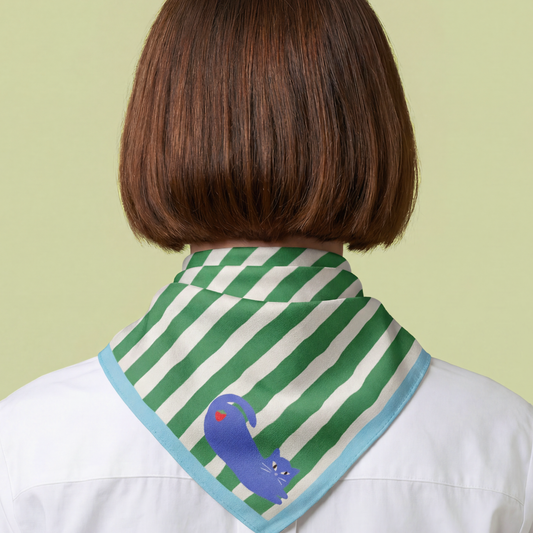 Person wearing a green and white striped scarf with a blue dinosaur design on a light green background