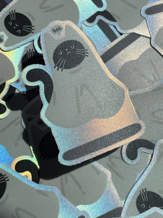 Holographic cat-shaped stickers on a reflective surface