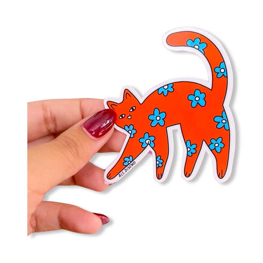 Hand holding a vinyl sticker of an orange cat with blue flowers on a white background