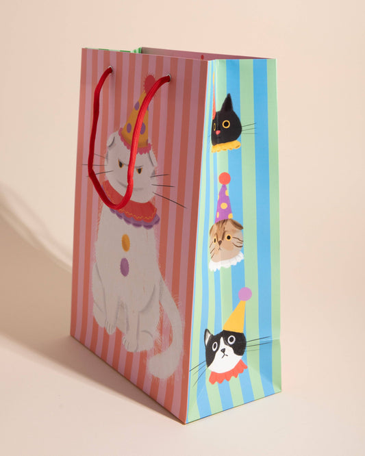 Gift bag with cat illustrations on a striped background