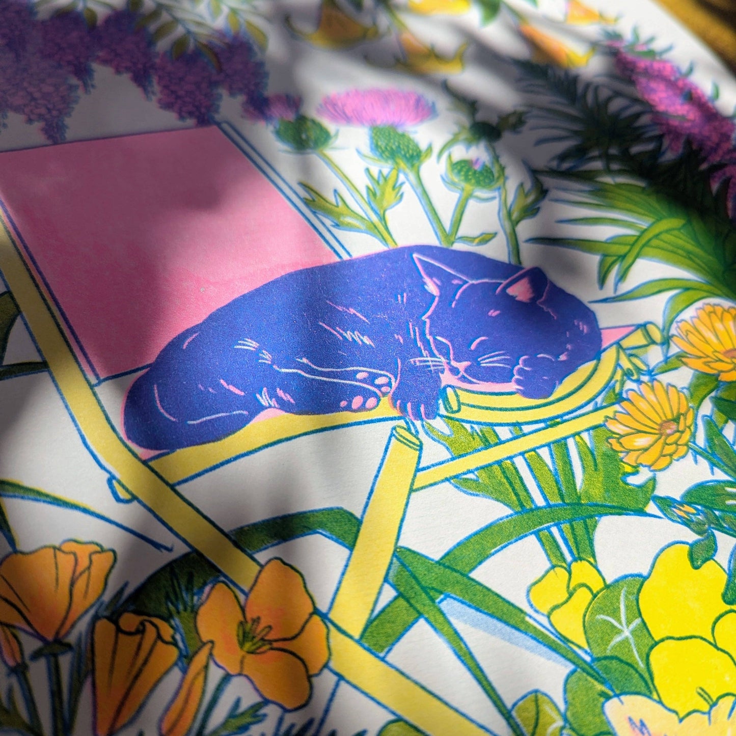 Colorful fabric with a cat design and floral patterns