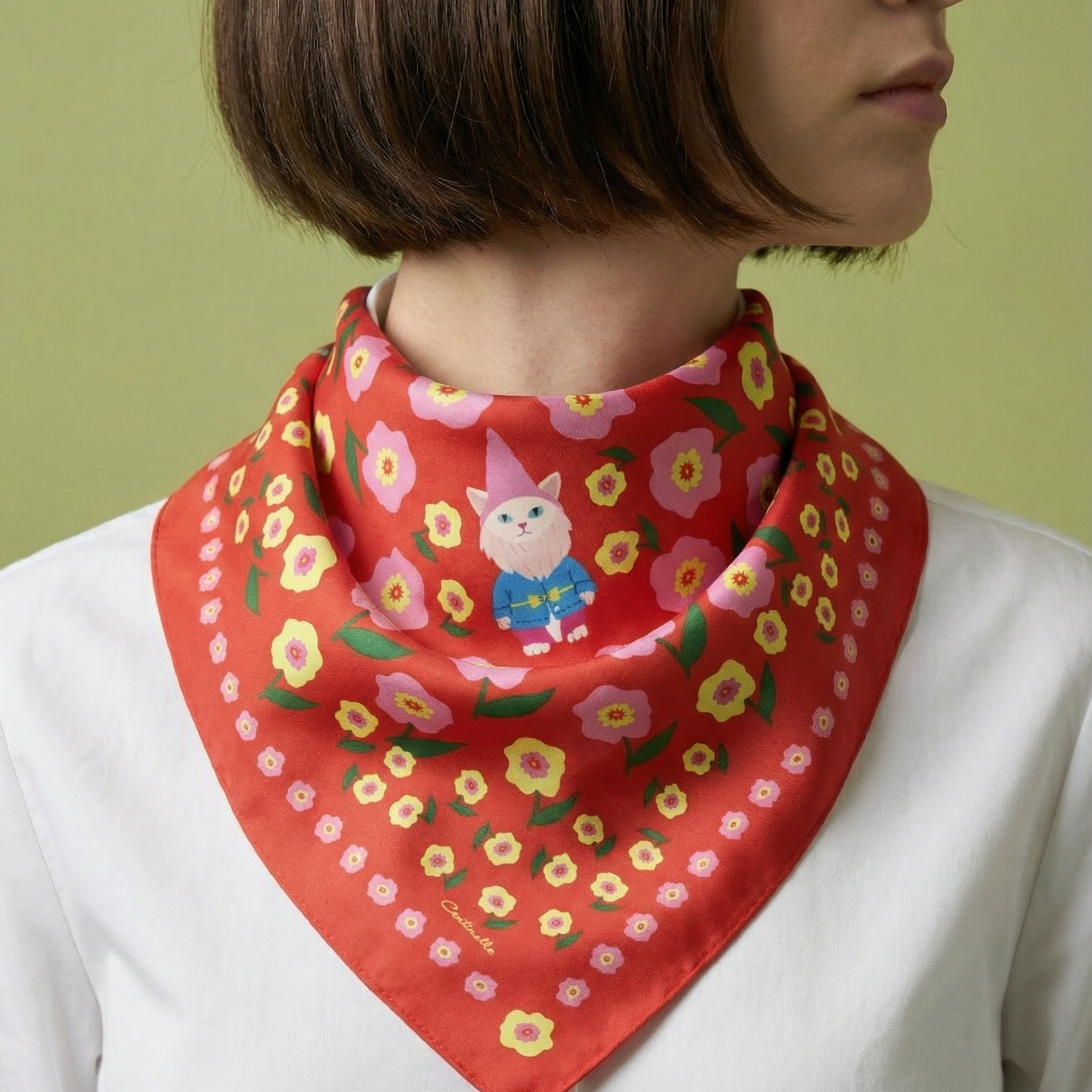 Person wearing a red floral scarf with a cartoon character on a green background