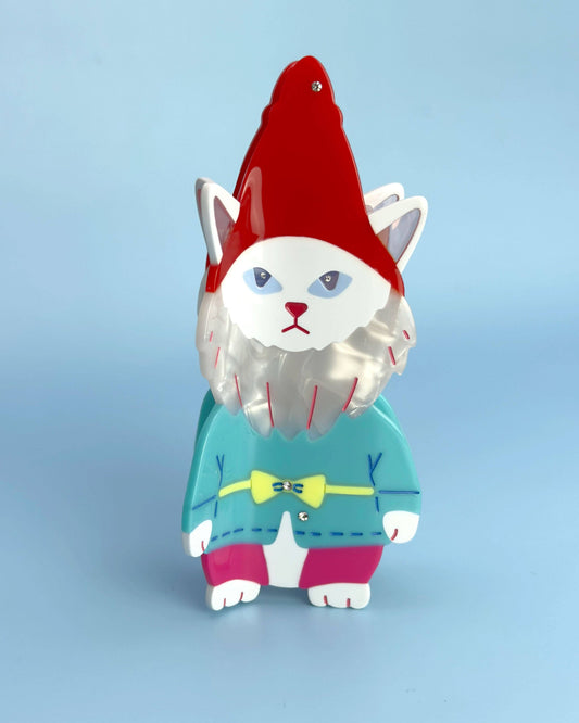 Cat-shaped gnome figurine with a red hat and teal sweater on a light blue background