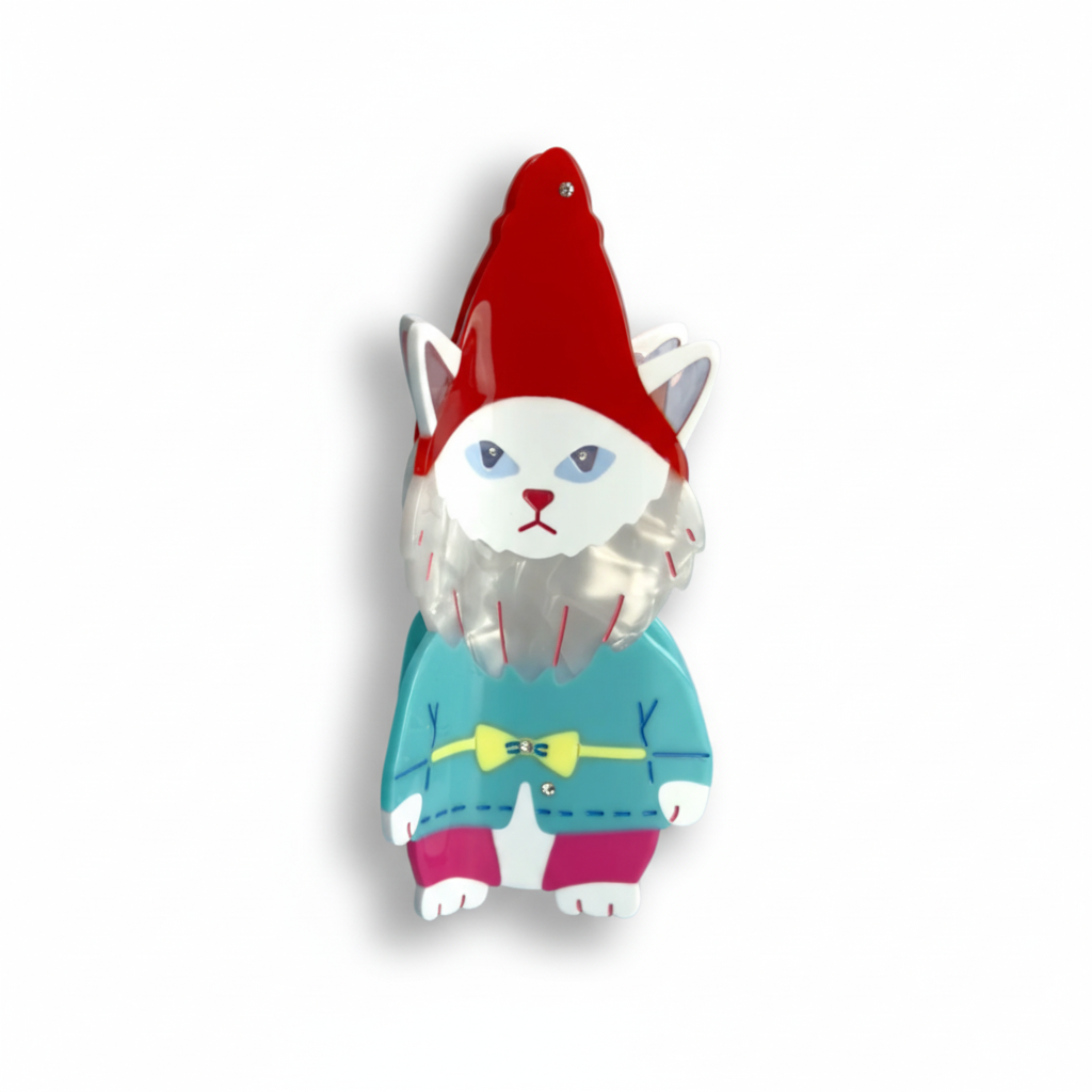 Cat-shaped ornament with a red hat and blue sweater on a white background