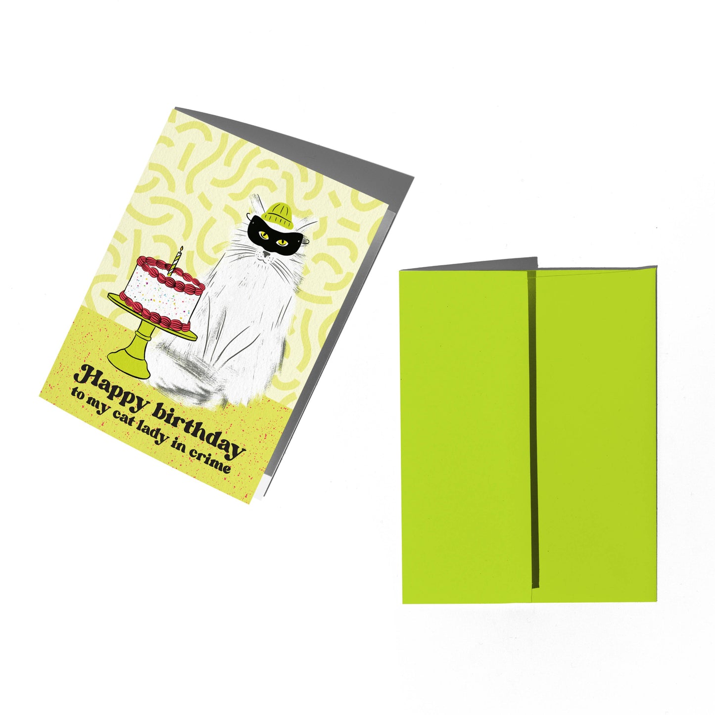 Birthday card with a cat design and green envelope on a white background