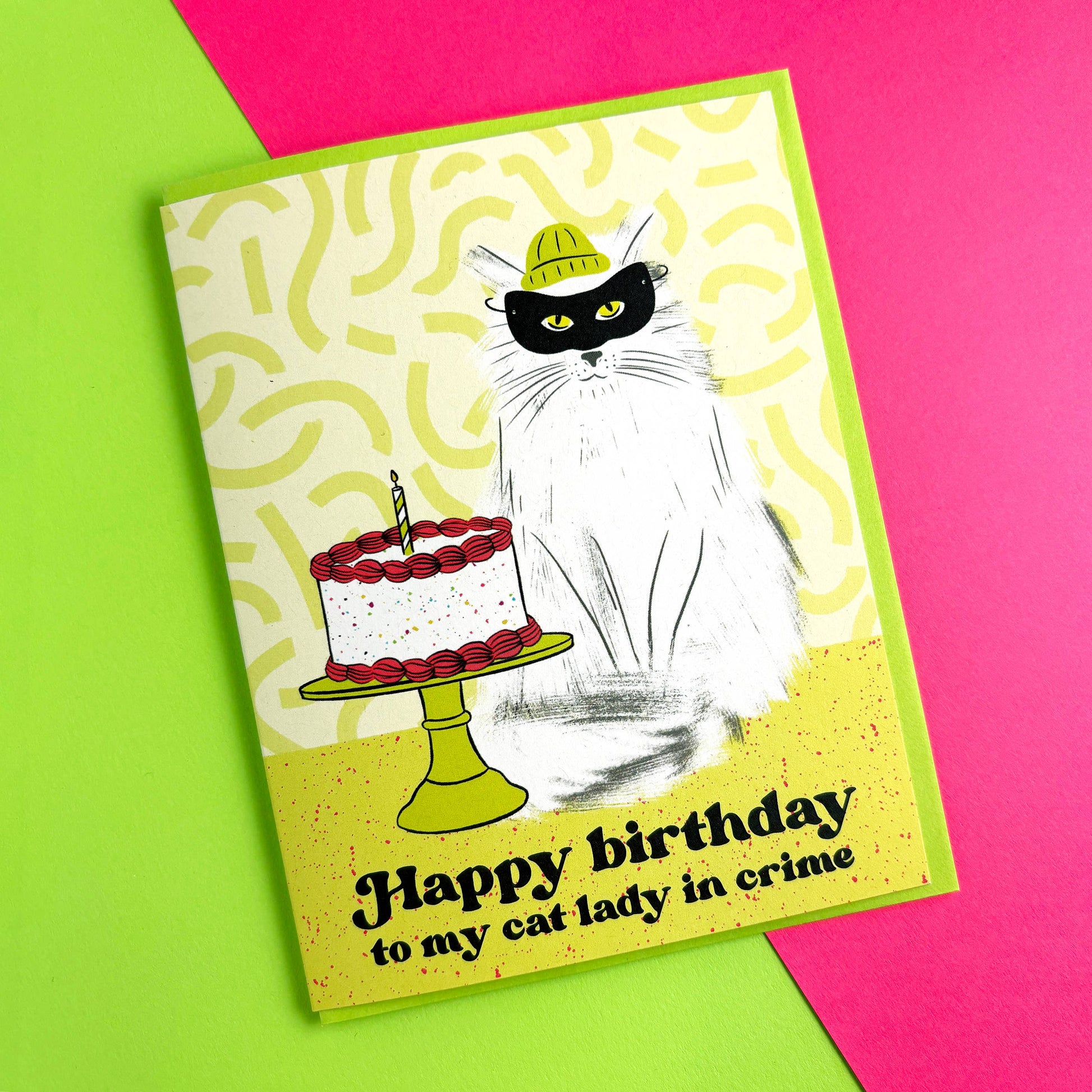 Birthday card with a cat and cake illustration on a colorful background