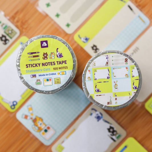 Two containers of sticky notes with colorful designs on a wooden surface.