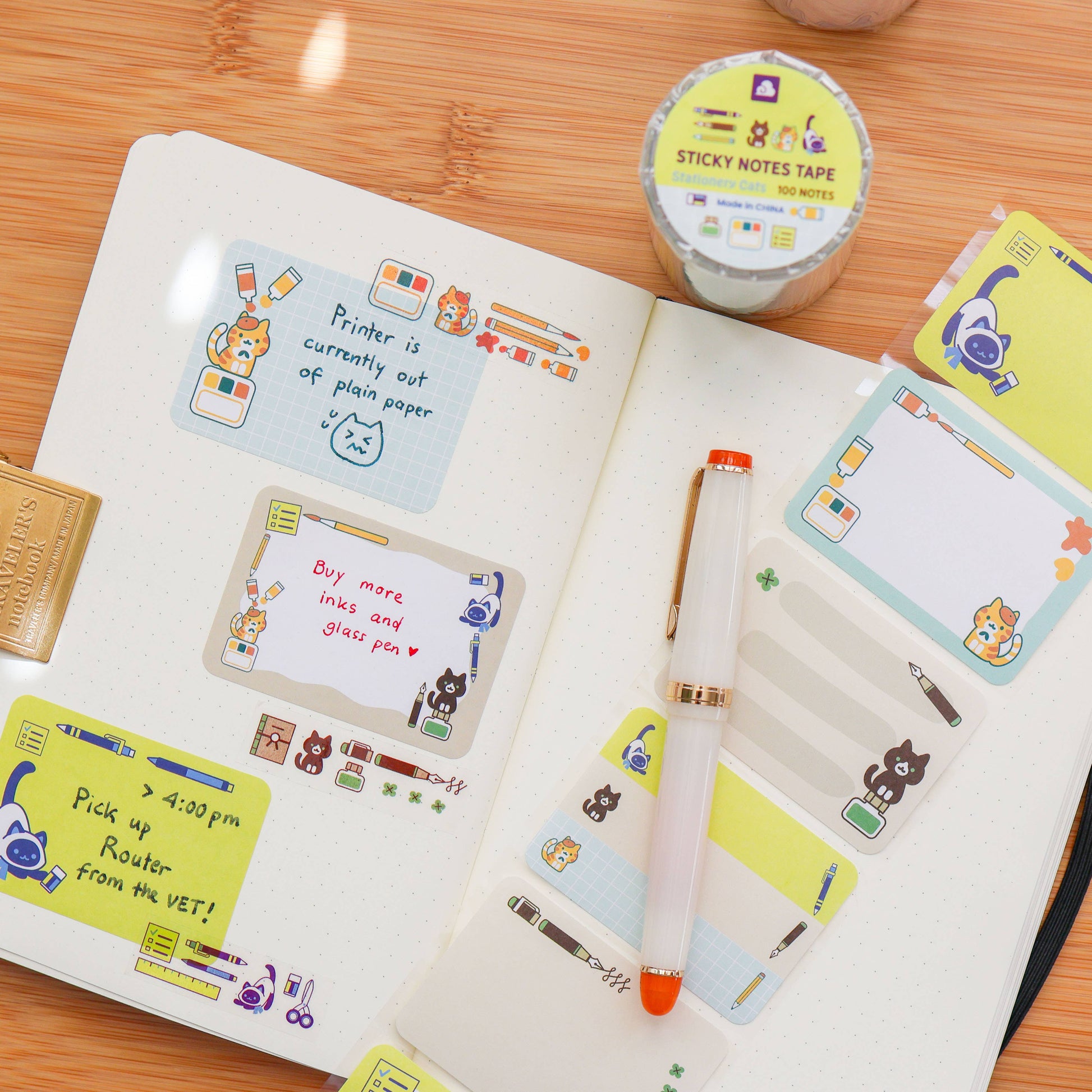 Notebook with colorful stickers and a pen on a wooden surface