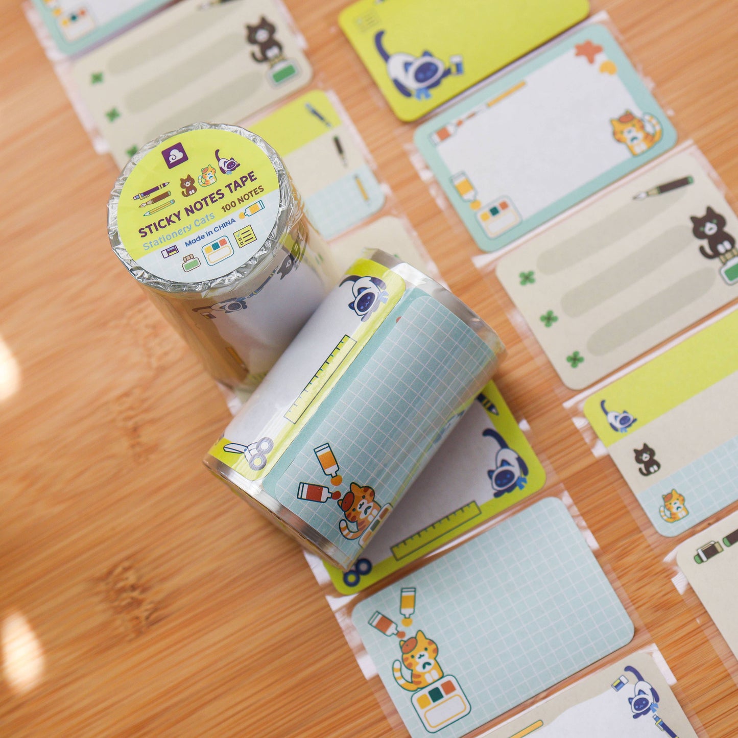 Sticky notes with cartoon designs on a wooden surface