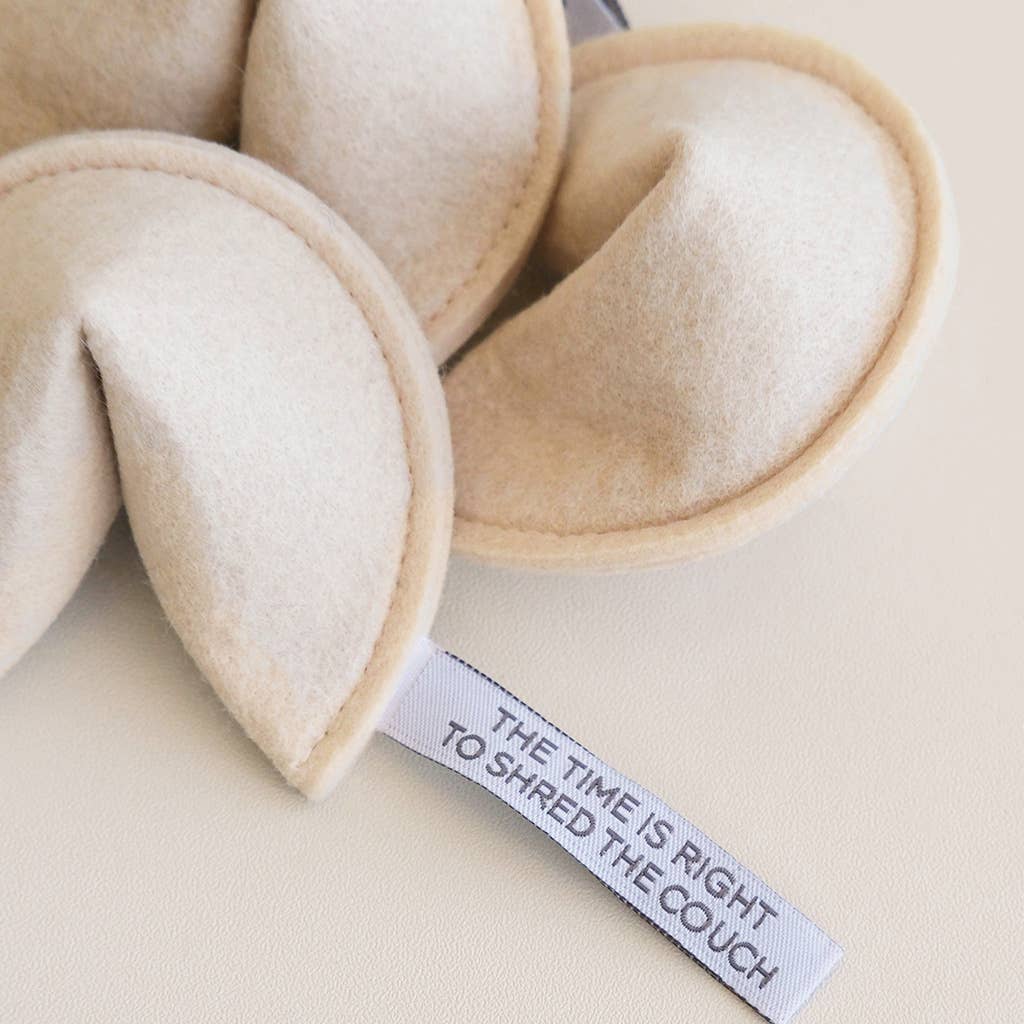 Beige fabric hearts with a humorous tag on a beige background