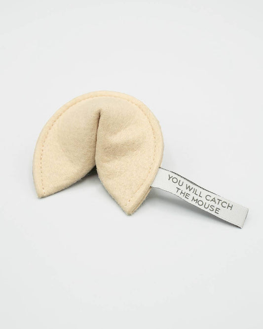 Beige fortune cookie with a tag on a white background