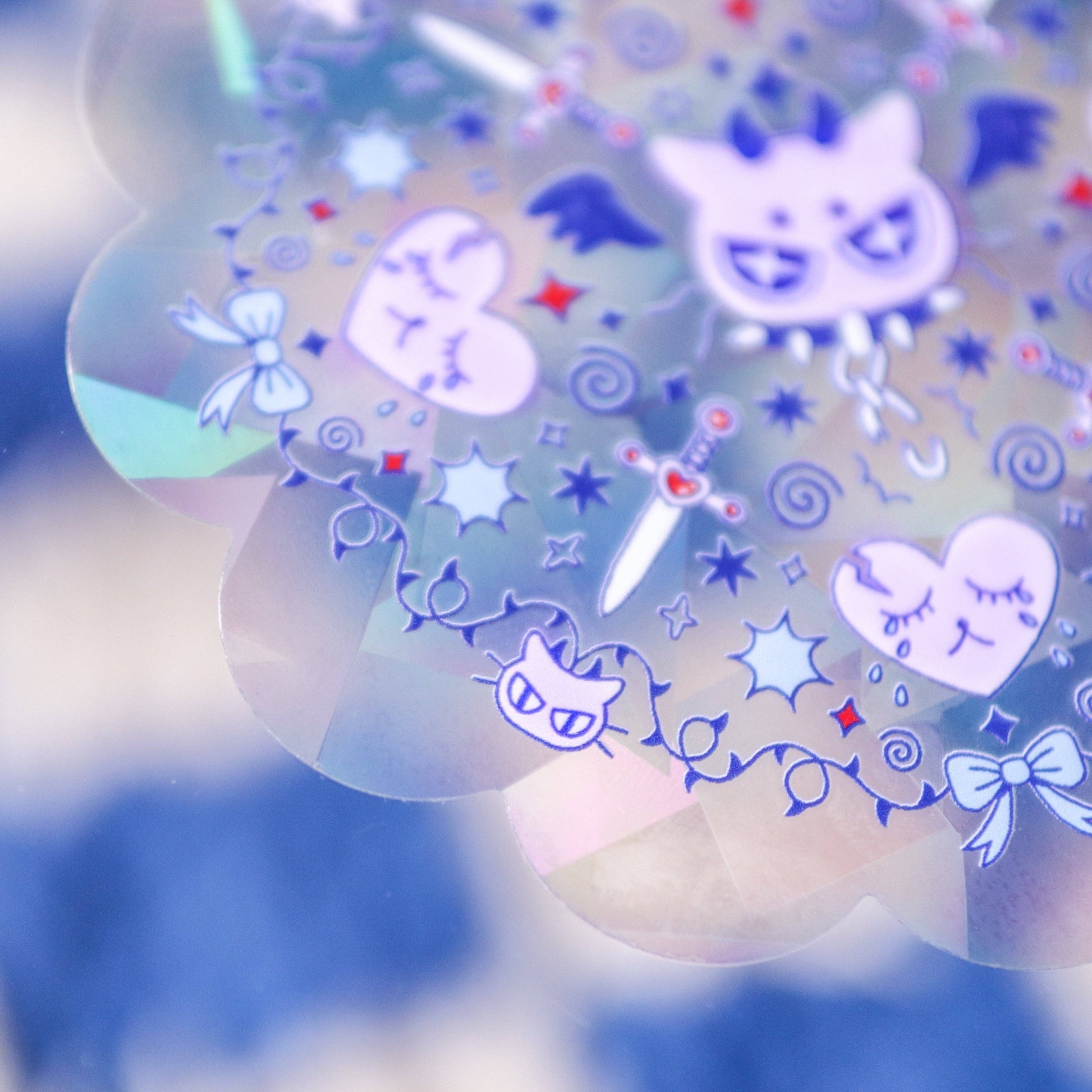 Decorative stickers with cartoon cat faces, stars, and bows on a blue and white background.