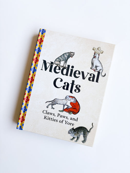 Book titled 'Medieval Cats' with illustrations of cats on a white background