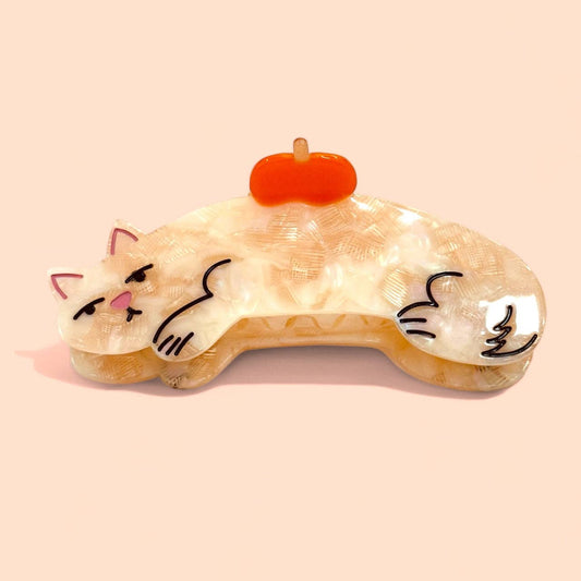 Cat-shaped sleep mask with a pumpkin on a beige background