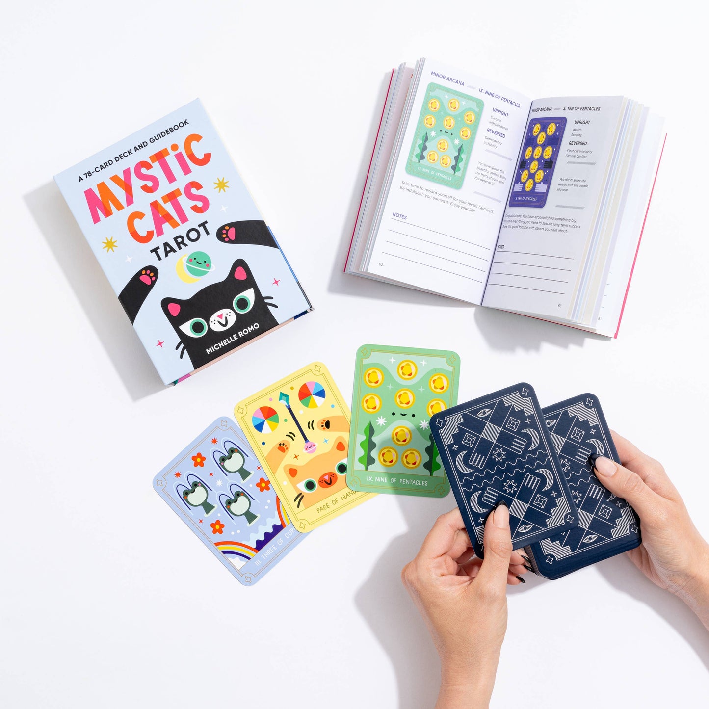 Mystic Cats Tarot cards with a book on a white background