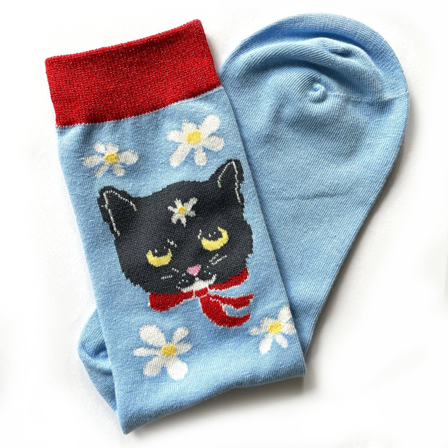 Blue socks with a black cat and flower design on a white background