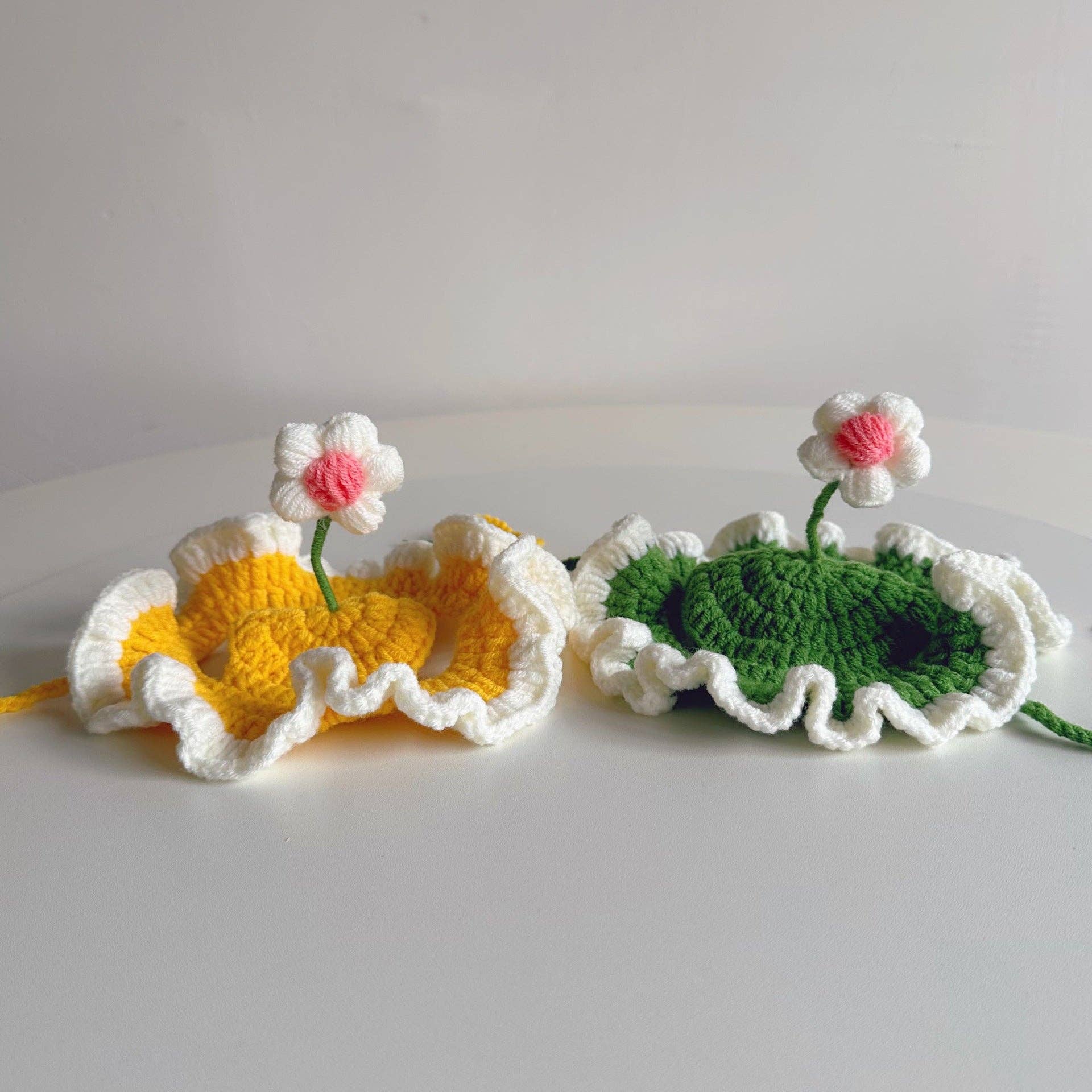 Two crocheted items resembling flowers and leaves on a white background