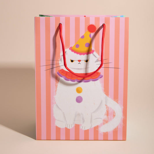 Gift bag with a cat design wearing a party hat on a striped background