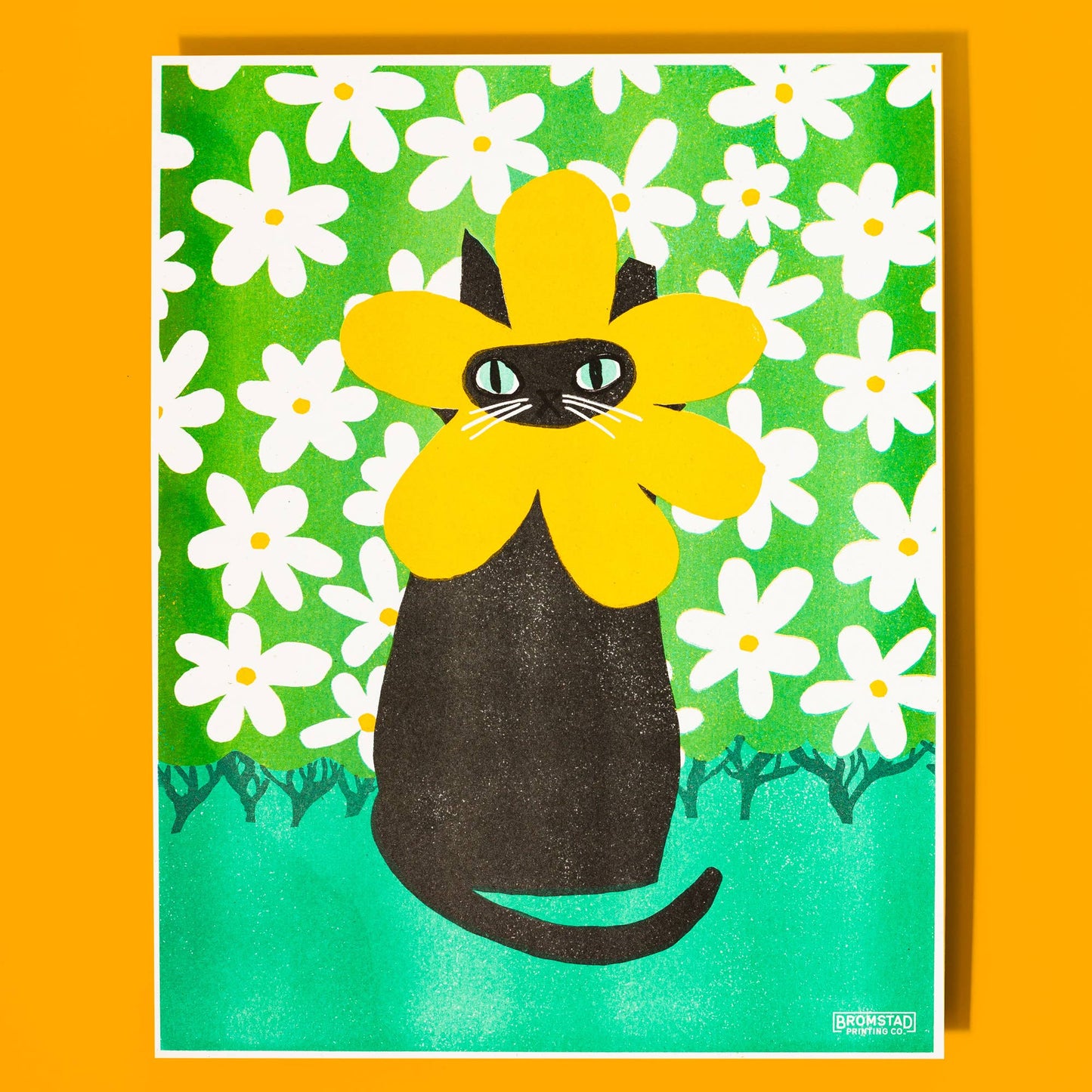 Illustration of a black cat with yellow flower-like petals on a green background with white flowers.