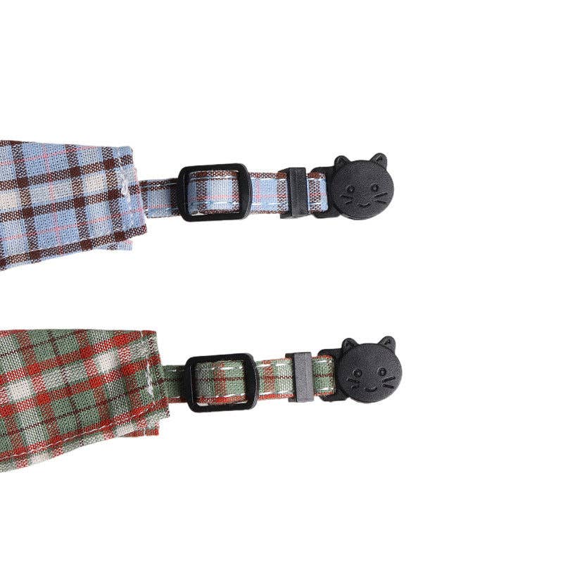 Plaid-patterned pet collars with black cat-shaped buckles on a white background