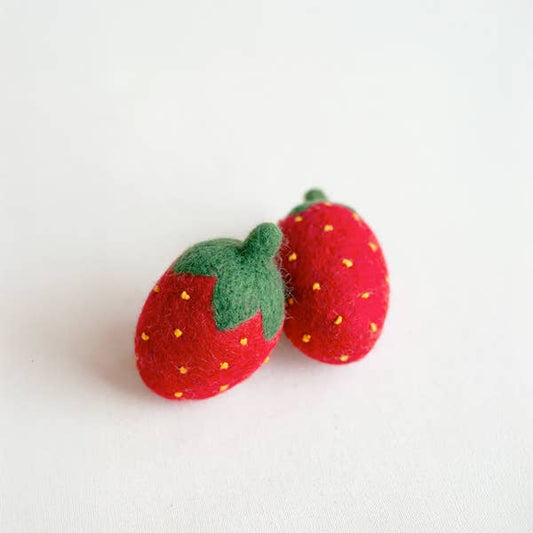 Two felt strawberries on a white background